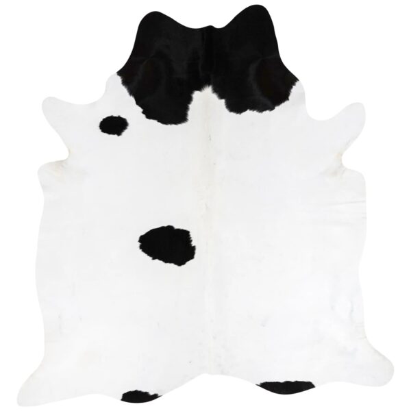 Minimal spotted black and white cowhide rug with open white space