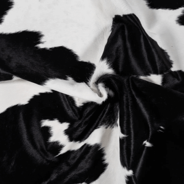 Real hair-on-hide cowhide rug fabric close-up with black and white contrast