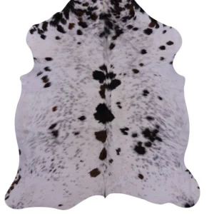 Real black and white cowhide rug with symmetrical natural hide patterns